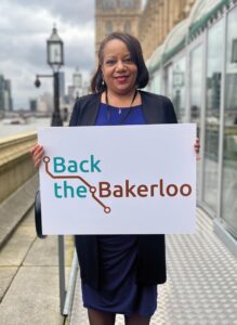 Mayor of Lewisham holding sign reading 'Back the Bakerloo'